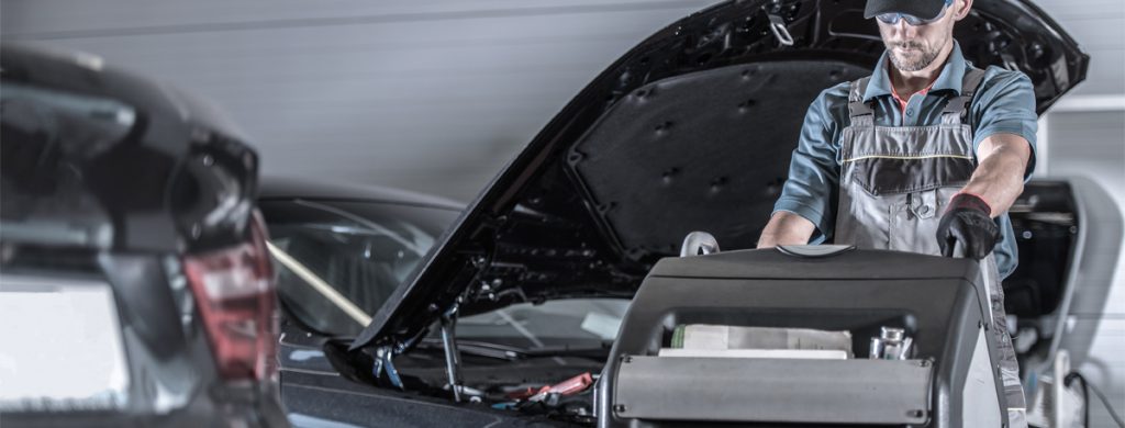 Mechanic regassing a vehicle - Car Air Conditioning Edington